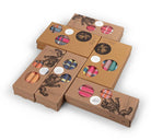 Set of brown cardboard boxes with colourful candles inside on a white background
