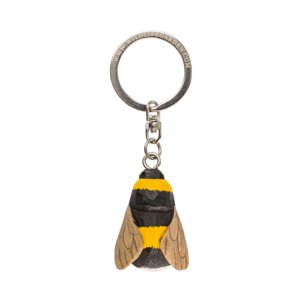 Keychain shaped like a bee with a black and yellow design on a white background