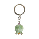 Keychain with green glass bead and metal ring on a white background