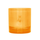Orange candle with a bee logo on a white background
