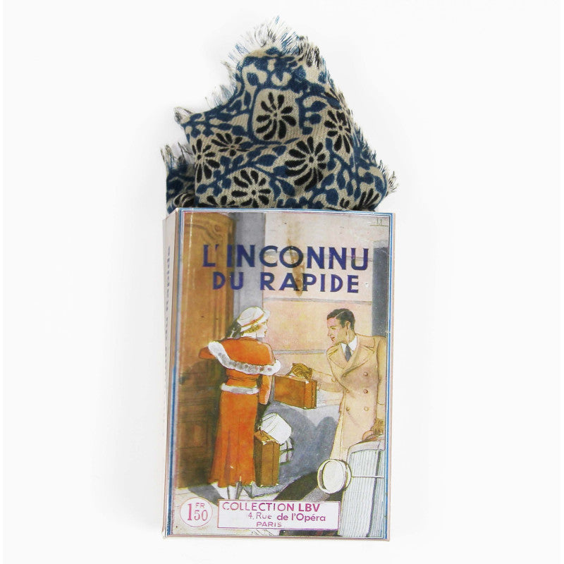 A vintage French pocket square set in its original illustrated box, titled 'L'INCONNU DU RAPIDE'. The pocket square features a blue and white floral pattern, and the box displays a retro illustration of a man and woman with the text 'COLLECTION LBV Paris'.