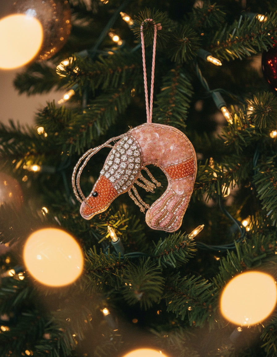 Decorative mouse ornament with beaded details on a white background
