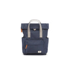 Photo showing the front of a small very dark blue backpack. There is a large pocket on the front with a brown zip pull, and the handles are grey.